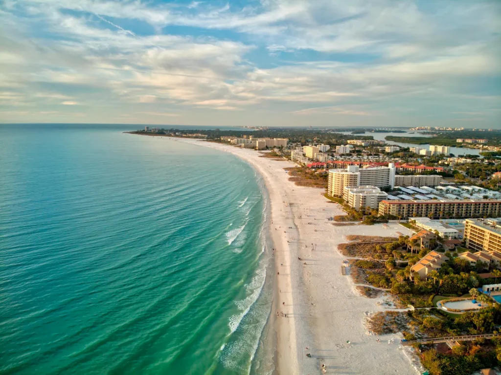 Aerial view of Siesta Key Beach in Sarasota, Florida, with turquoise Gulf water and white sand shoreline