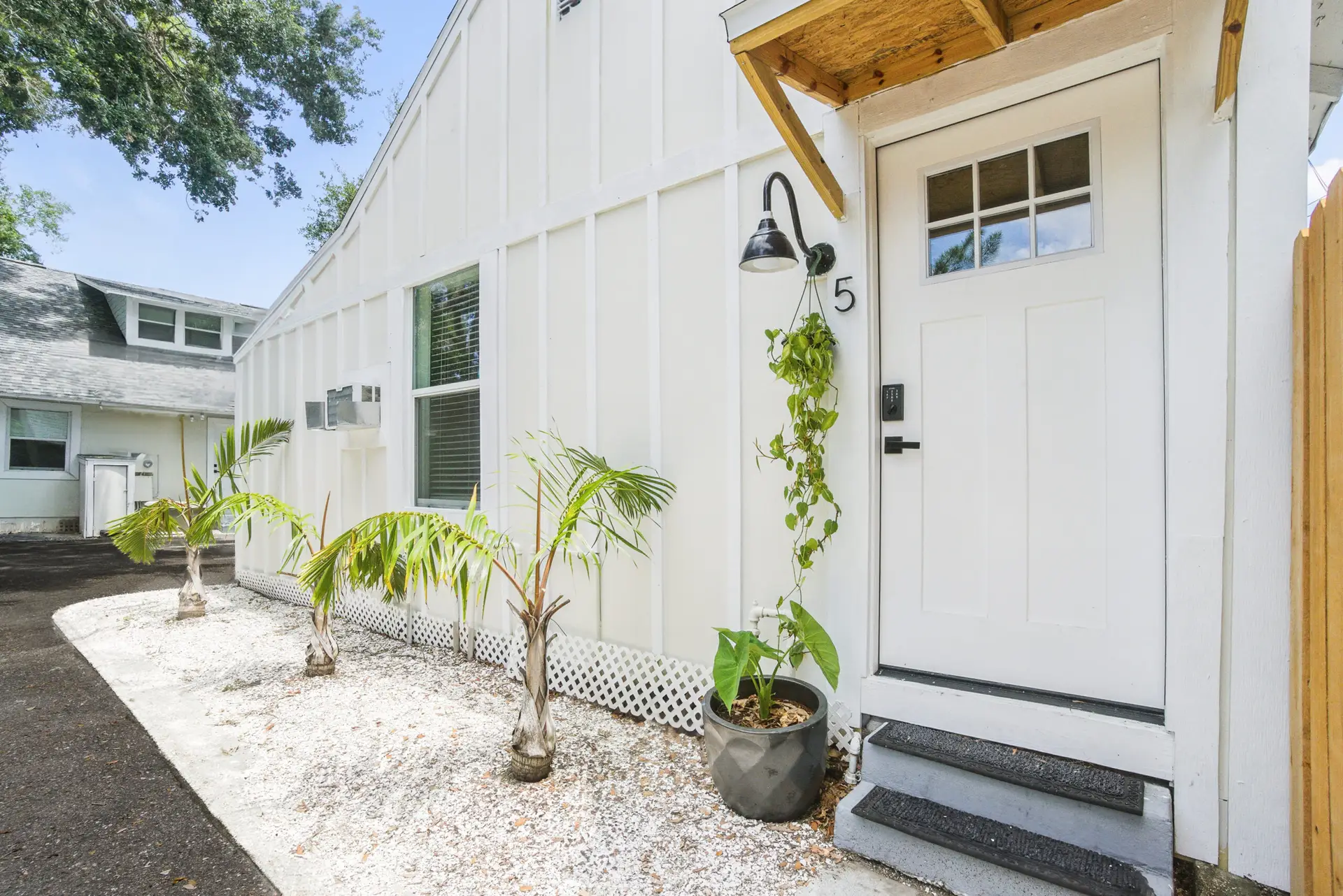 Grove Studio Two entrance with tropical plants and keypad lock – Unit 5 vacation rental St. Petersburg FL