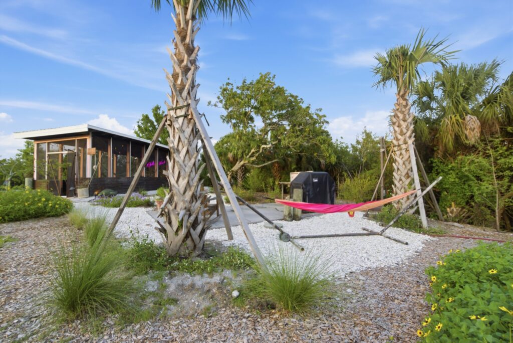 Butterfly garden plantings and palms outside the tiny homes on Shellmate Island, Sarasota