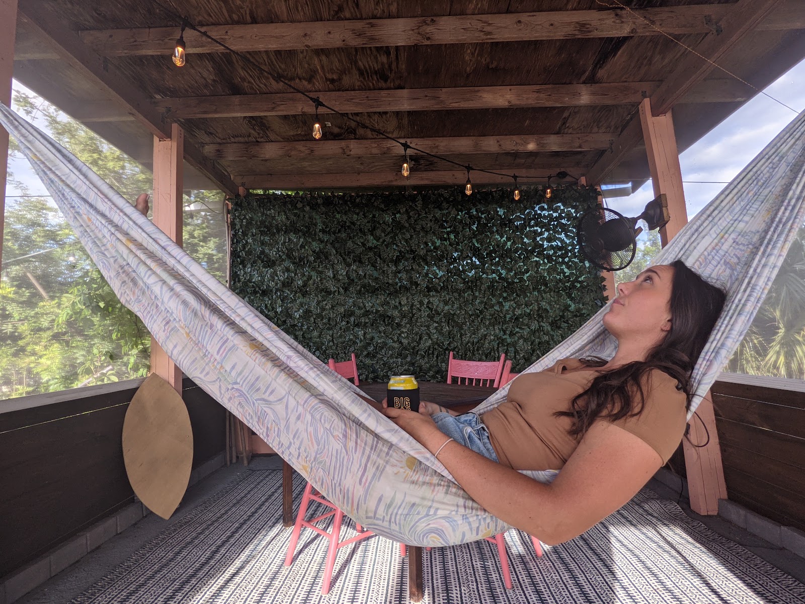 Guest relaxing in a hammock in the screened lounge on Shellmate Island, Sarasota